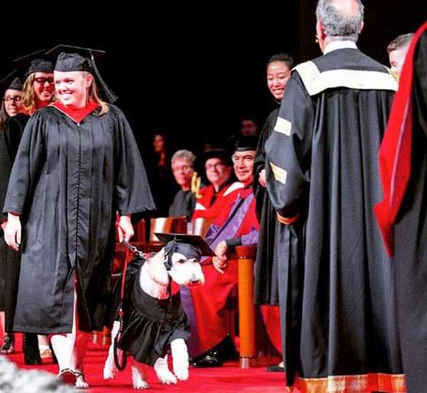 Barkley service dog and Devon MacPherson at graduation