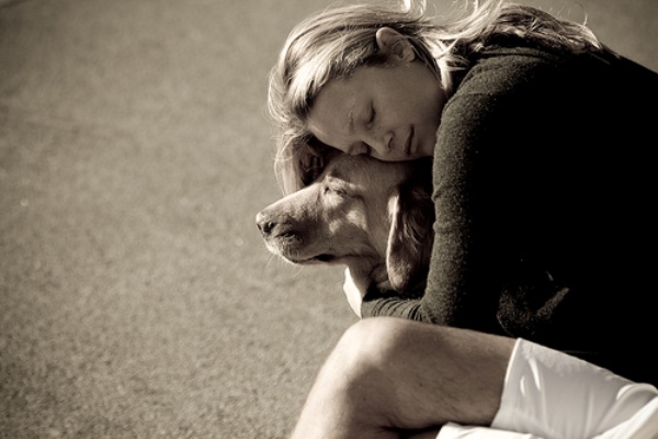 woman hugging dog